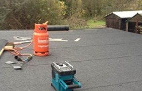 Felt flat roof being laid with a gas torch